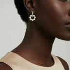 Woman wearing pearl cluster huggie hoop earrings in silver | VAHN Jewels