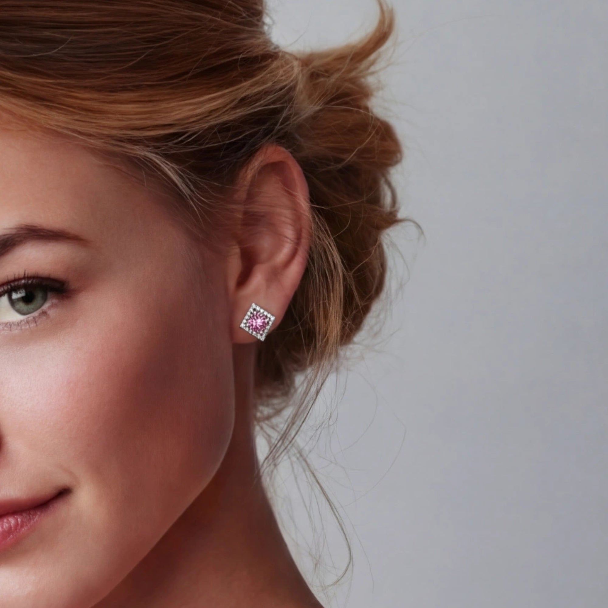 Woman wearing pink moissanite halo stud earrings in silver | VAHN Jewels