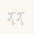 Silver bow pearl drop earrings in rhodium-plated 925 sterling silver with double blush freshwater pearl drops by VAHN Jewels