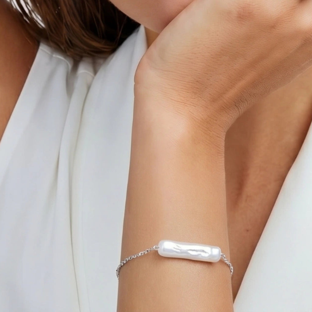Woman wearing single baroque pearl chain bracelet in silver | VAHN Jewels
