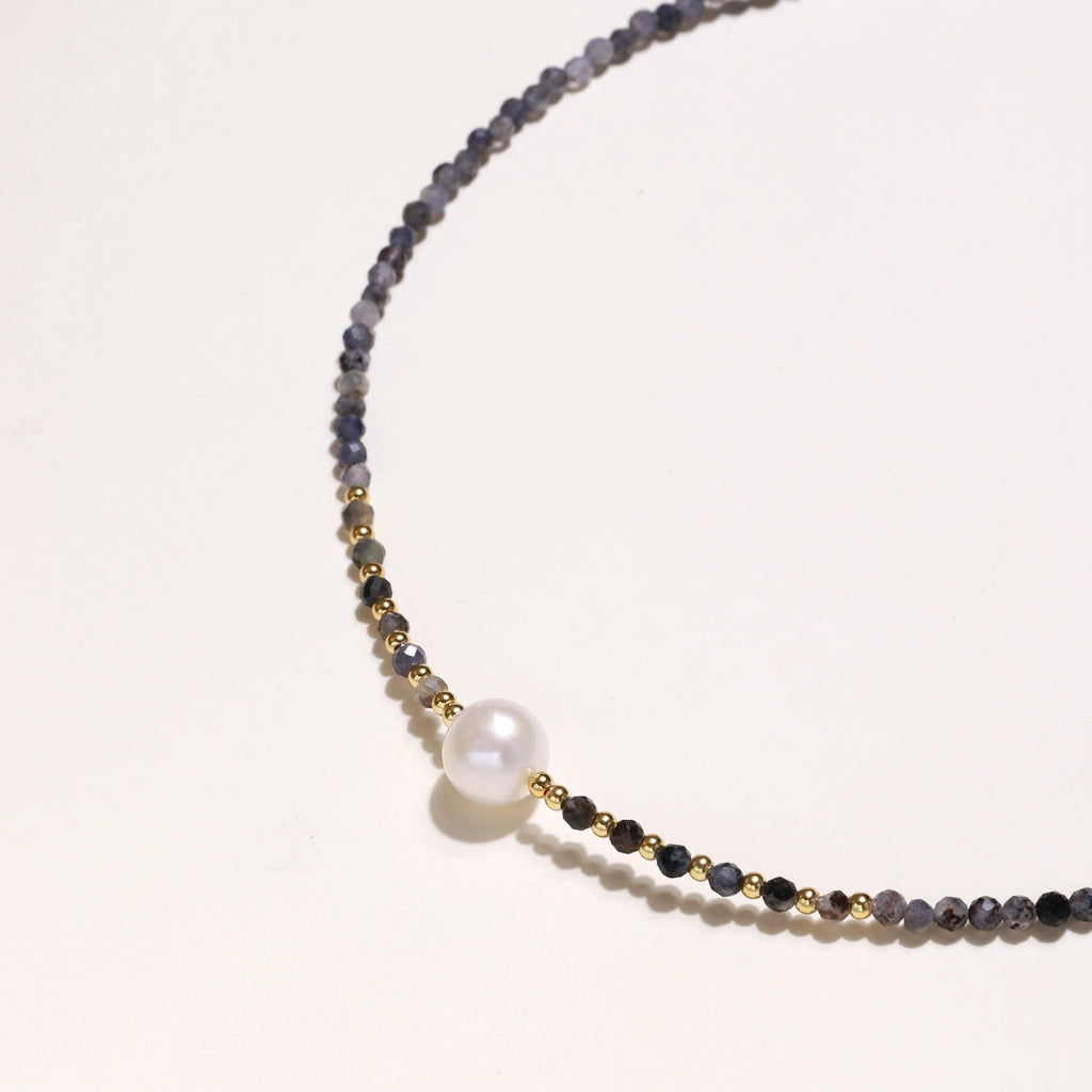 Detail view of faceted iolite beads and gold vermeil accents on twilight pearl necklace by VAHN Jewels