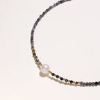 Detail view of faceted iolite beads and gold vermeil accents on twilight pearl necklace by VAHN Jewels