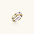 Side view of two-tone band ring with gold vermeil borders and blue zirconia in 925 sterling silver