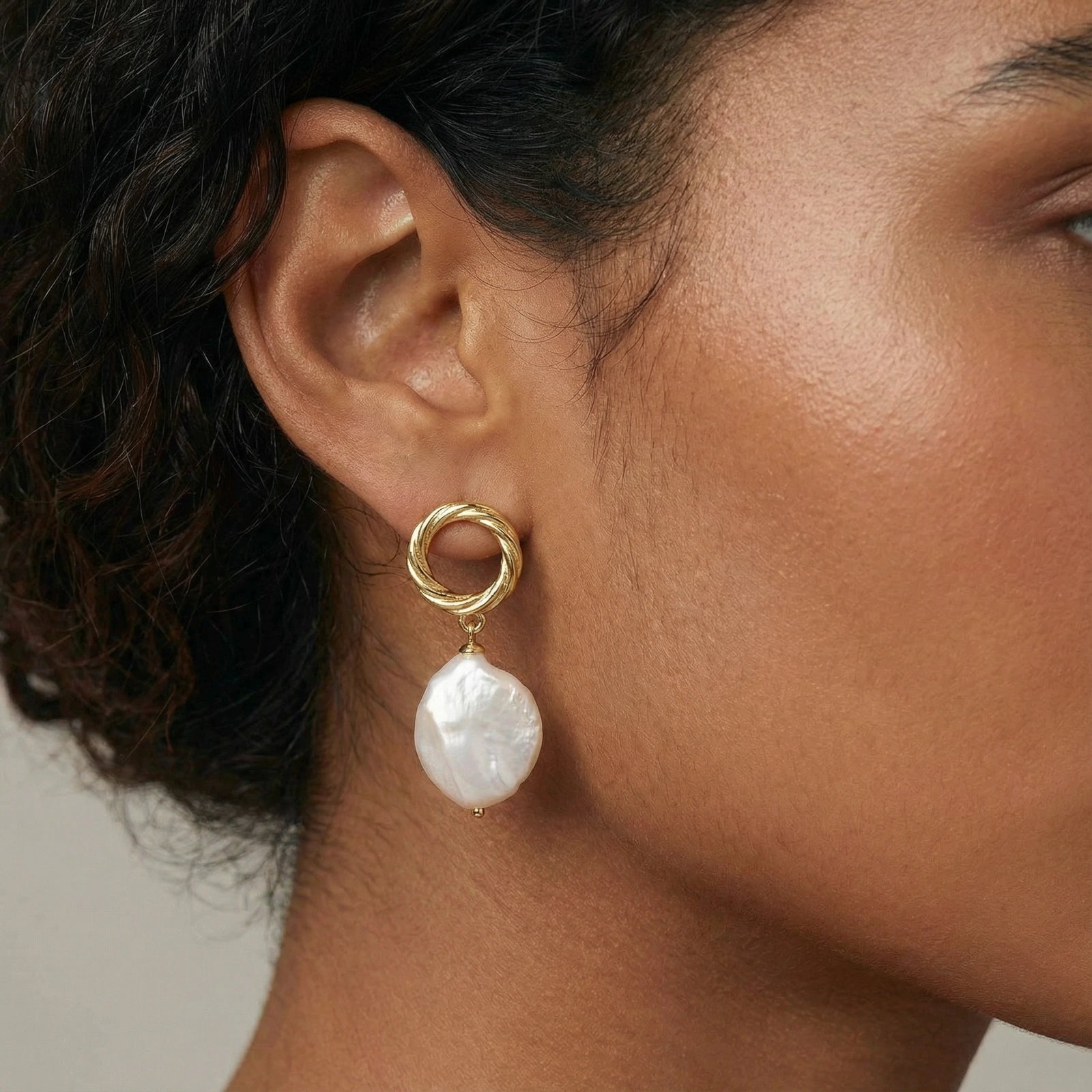 Woman wearing baroque pearl drop earrings in 18K gold vermeil by VAHN Jewels