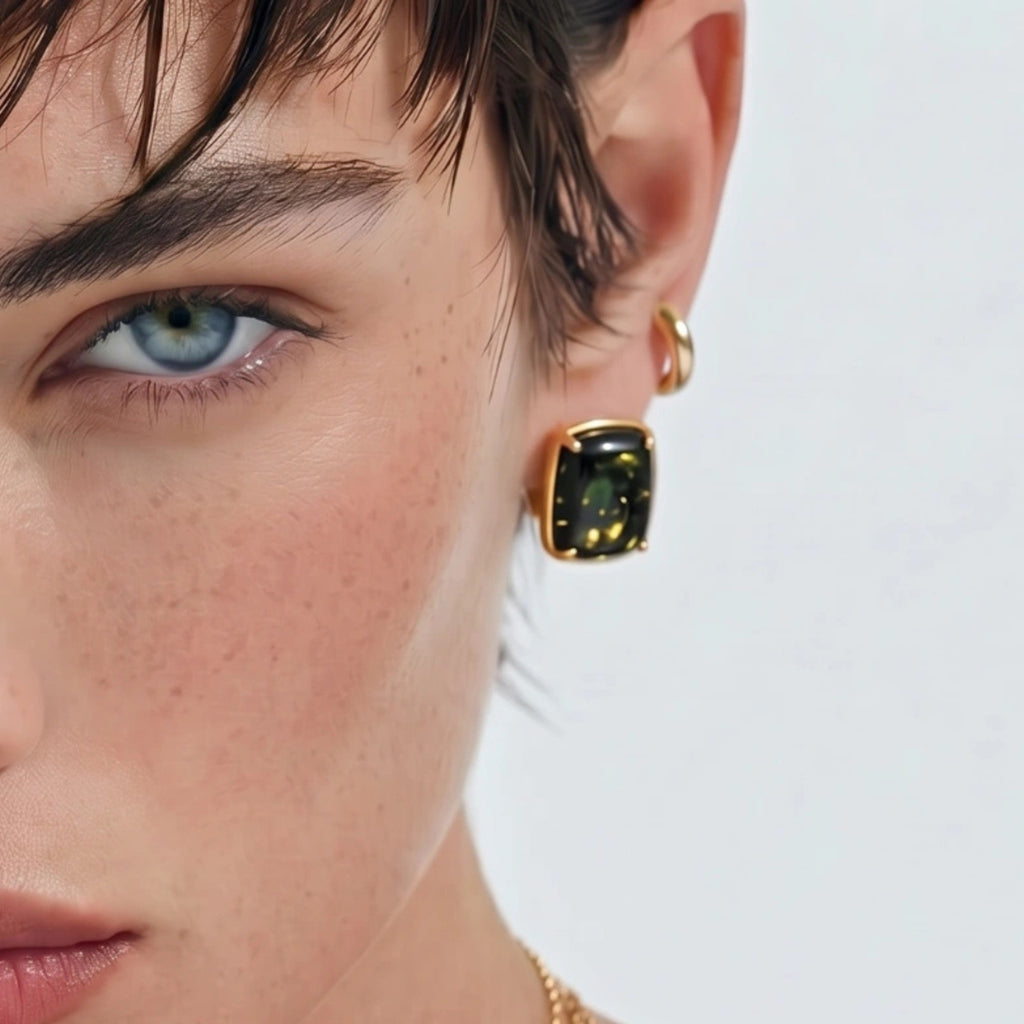 Woman wearing green amber cabochon stud earrings in 18K gold-plated 925 sterling silver by VAHN Jewels