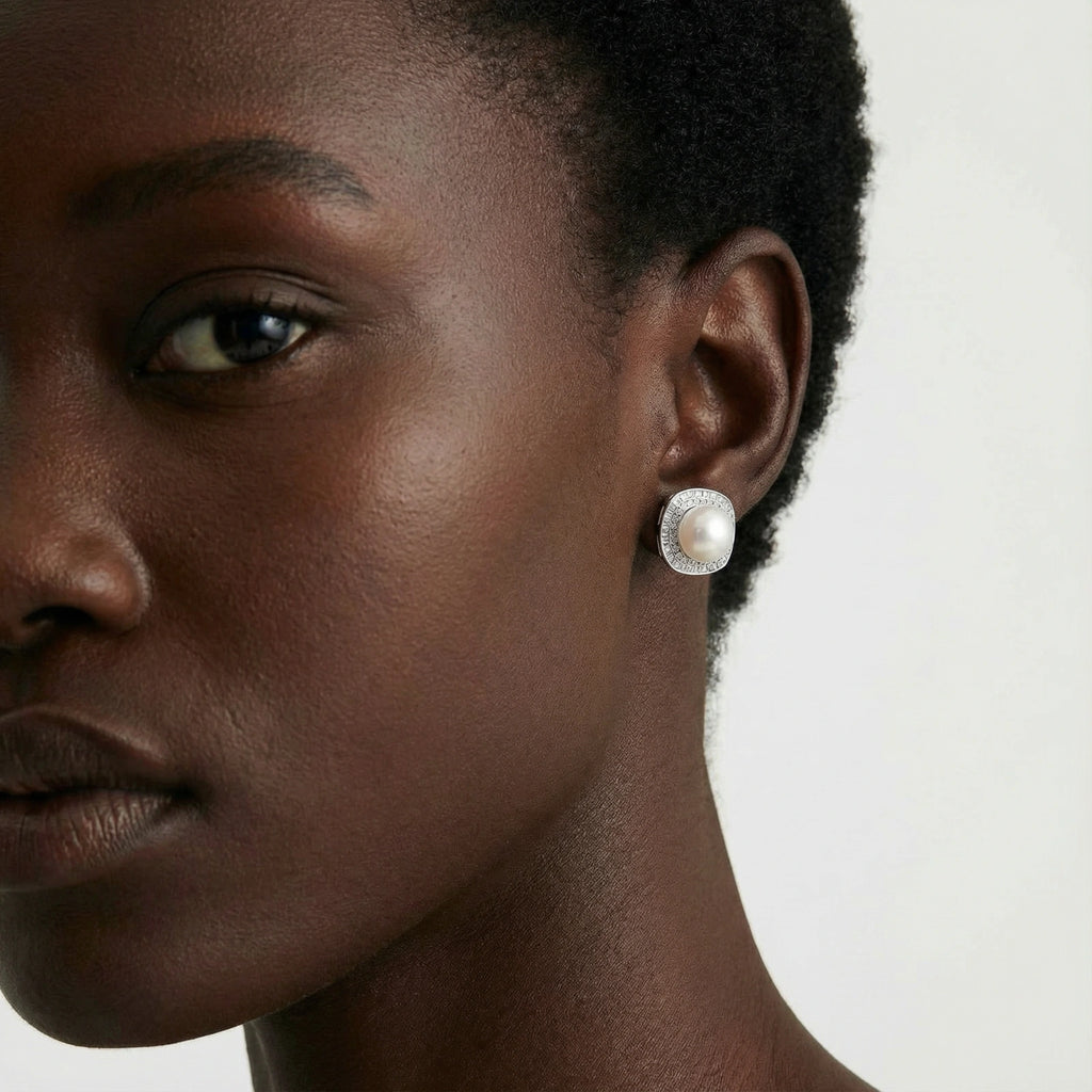 Woman wearing pearl halo stud earrings in rhodium-plated 925 sterling silver by VAHN Jewels