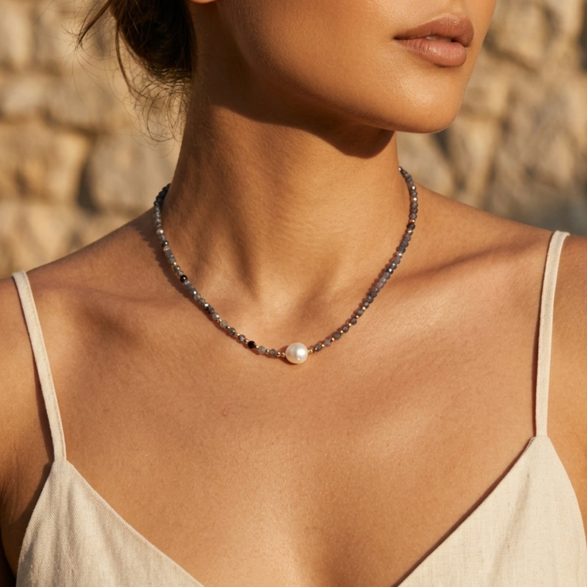 Woman wearing twilight iolite pearl necklace with faceted iolite beads and freshwater pearl by VAHN Jewels