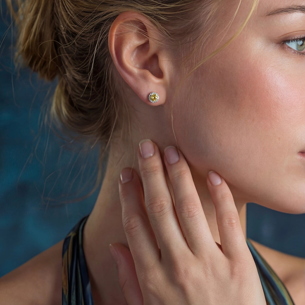Woman wearing yellow moissanite halo stud earrings in 925 sterling silver by VAHN Jewels