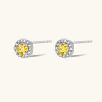 Close-up pair of yellow moissanite halo stud earrings in 925 sterling silver by VAHN Jewels