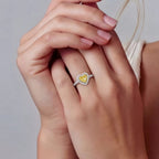 Woman wearing yellow moissanite heart halo ring in silver | VAHN Jewels
