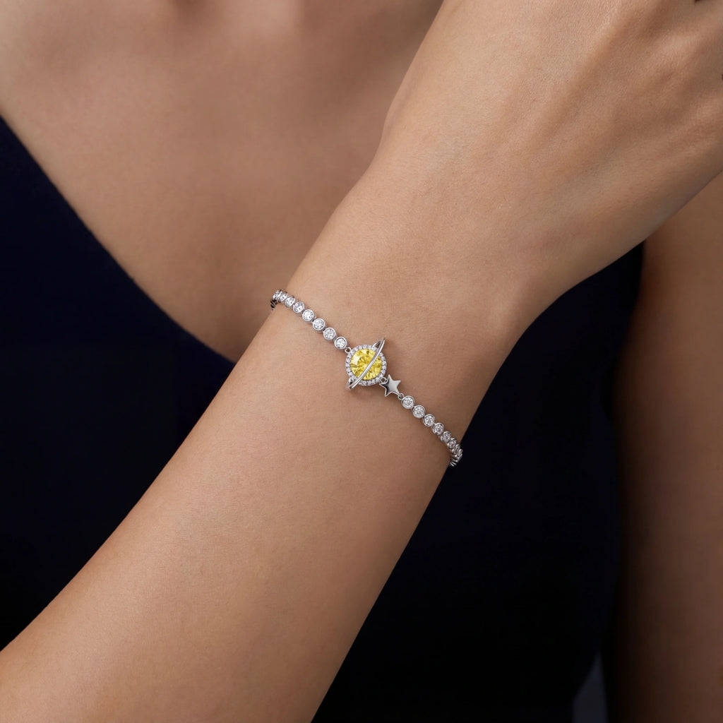Woman wearing yellow moissanite Saturn silver bracelet in 925 sterling silver by VAHN Jewels