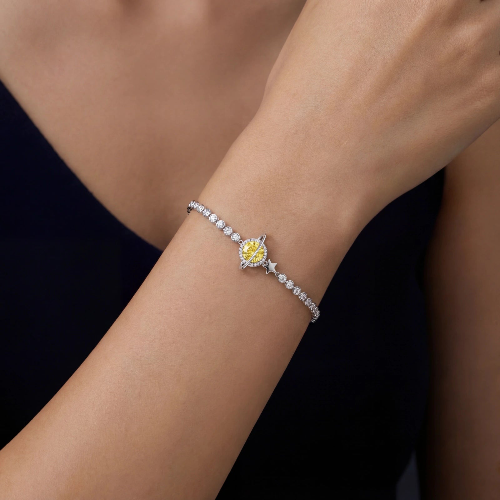 Woman wearing yellow moissanite Saturn silver bracelet in 925 sterling silver by VAHN Jewels