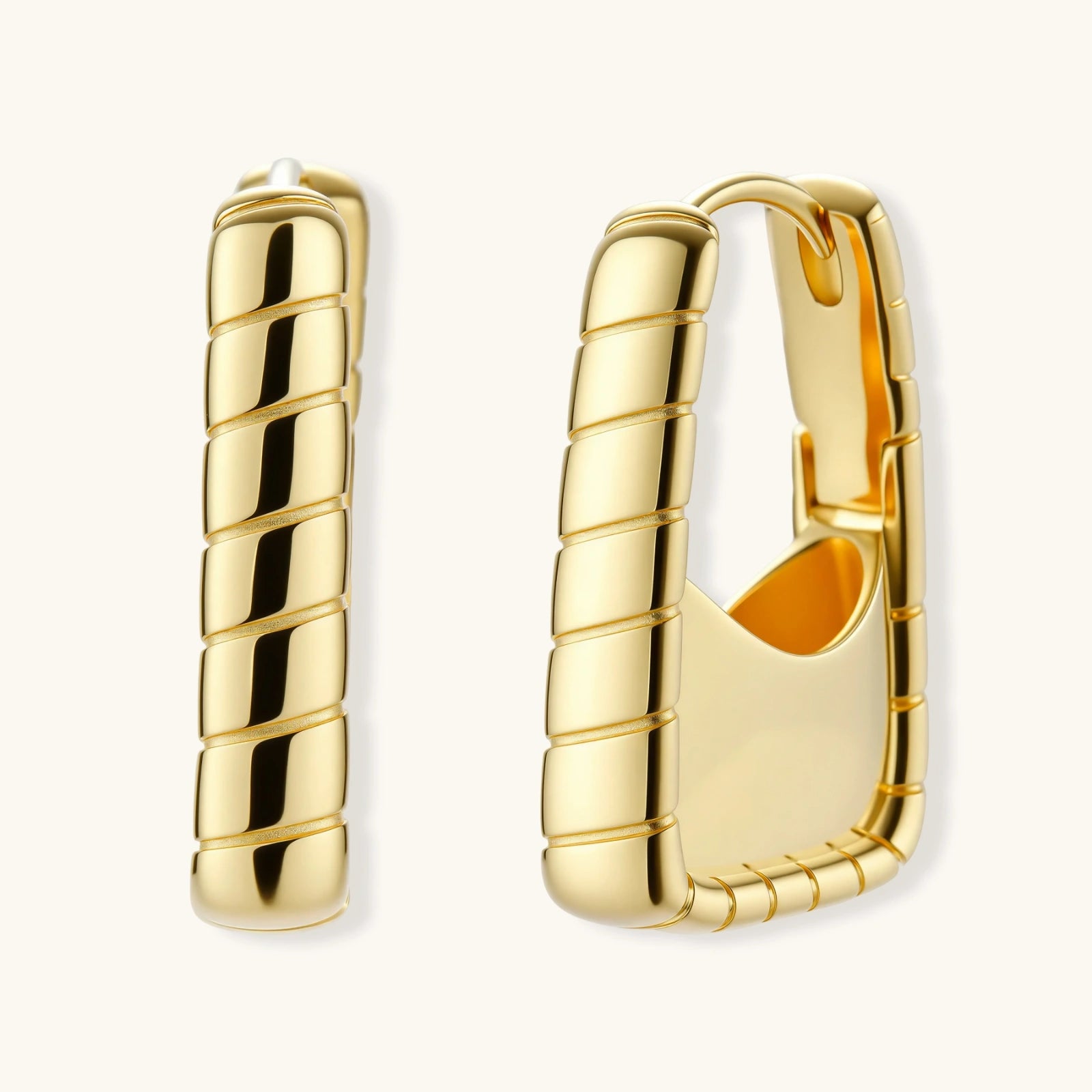 Pair of gold bamboo huggie hoop earrings — architectural statement jewelry