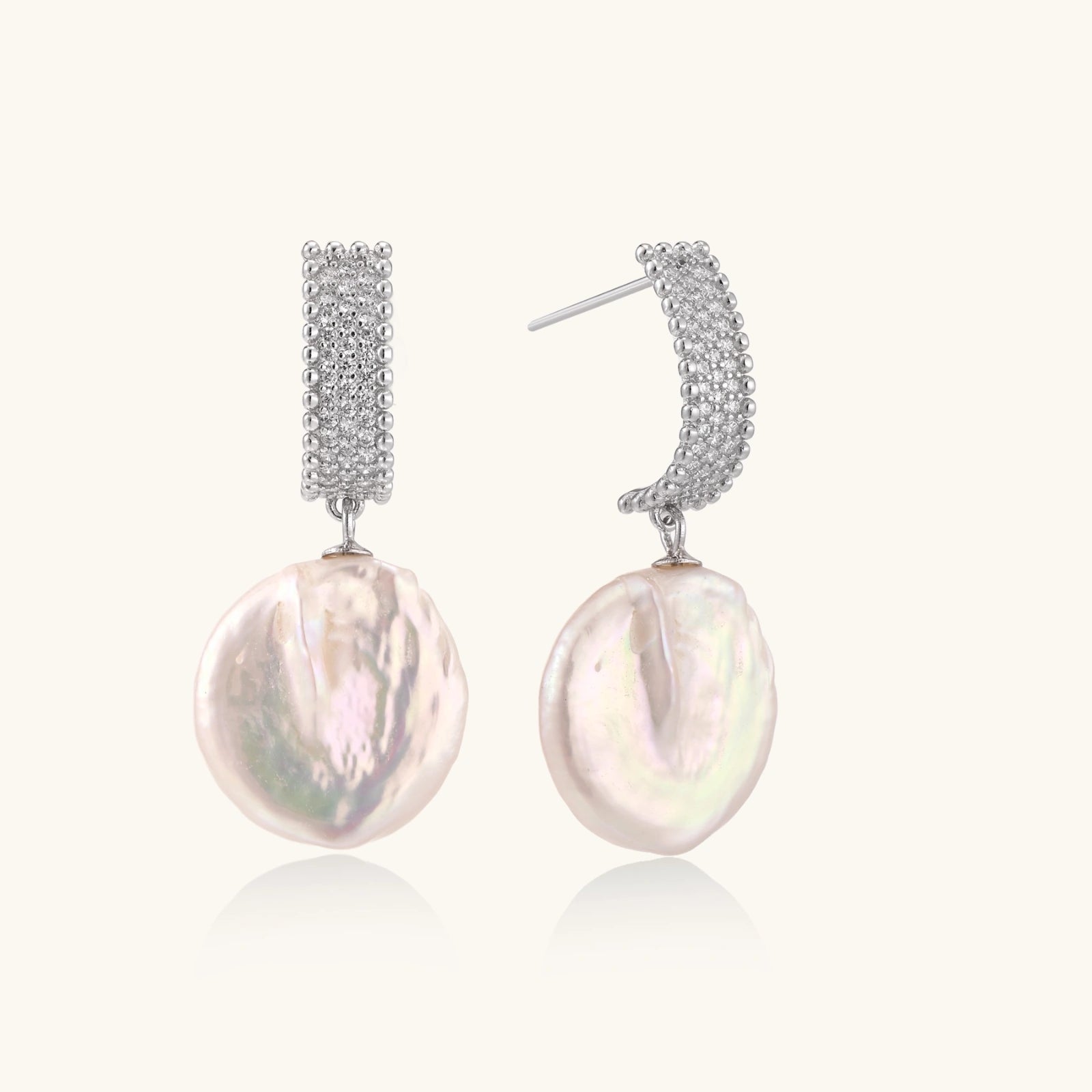 Baroque pearl drop earrings with rhodium silver bead grid on white background