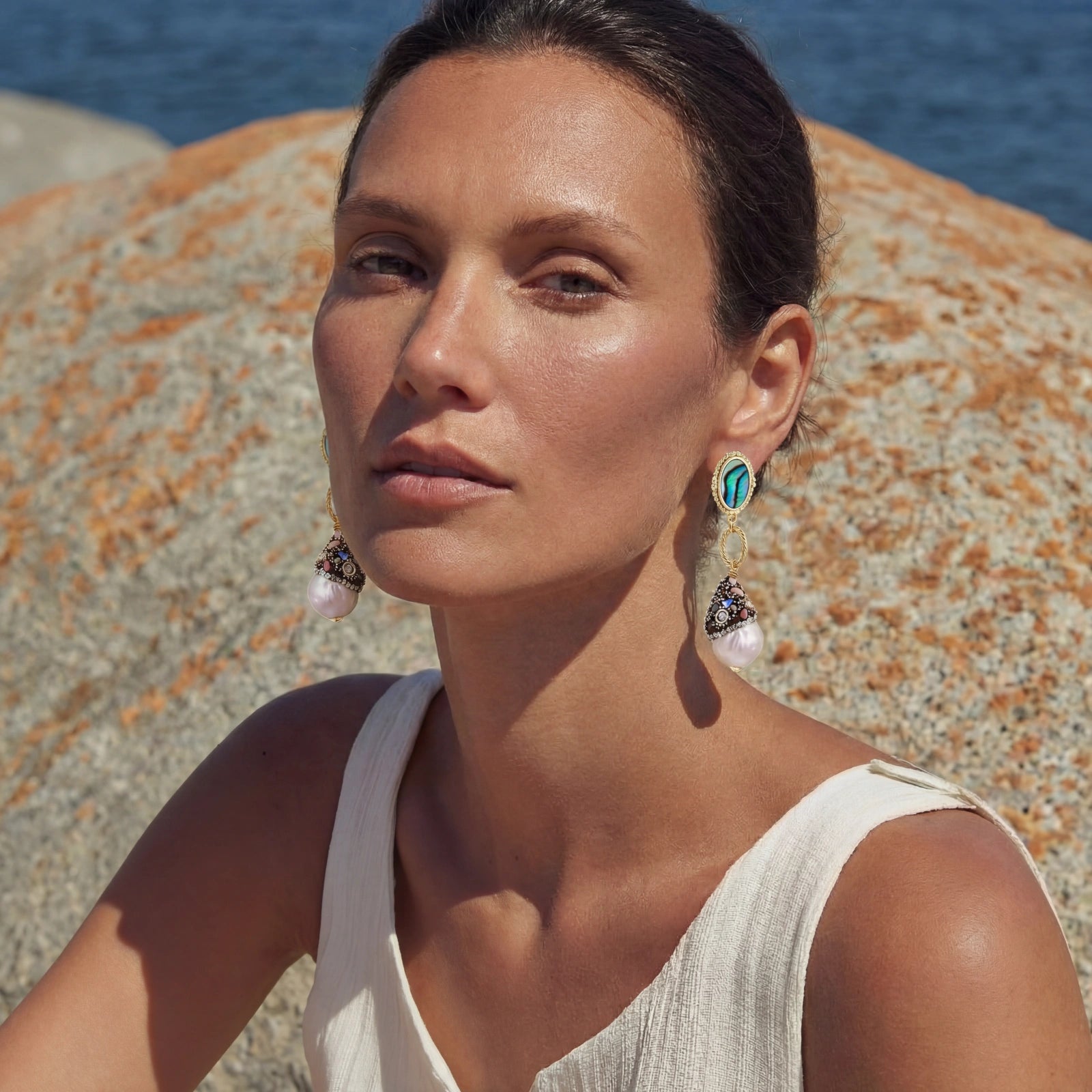 Woman wearing baroque pearl statement earrings — bold elegant jewelry