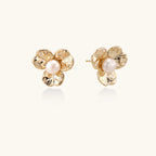 Pair of gold bloom pearl stud earrings with hammered petal detailbackground