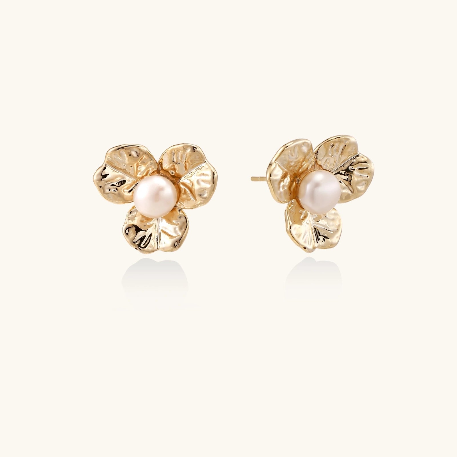 Pair of gold bloom pearl stud earrings with hammered petal detailbackground