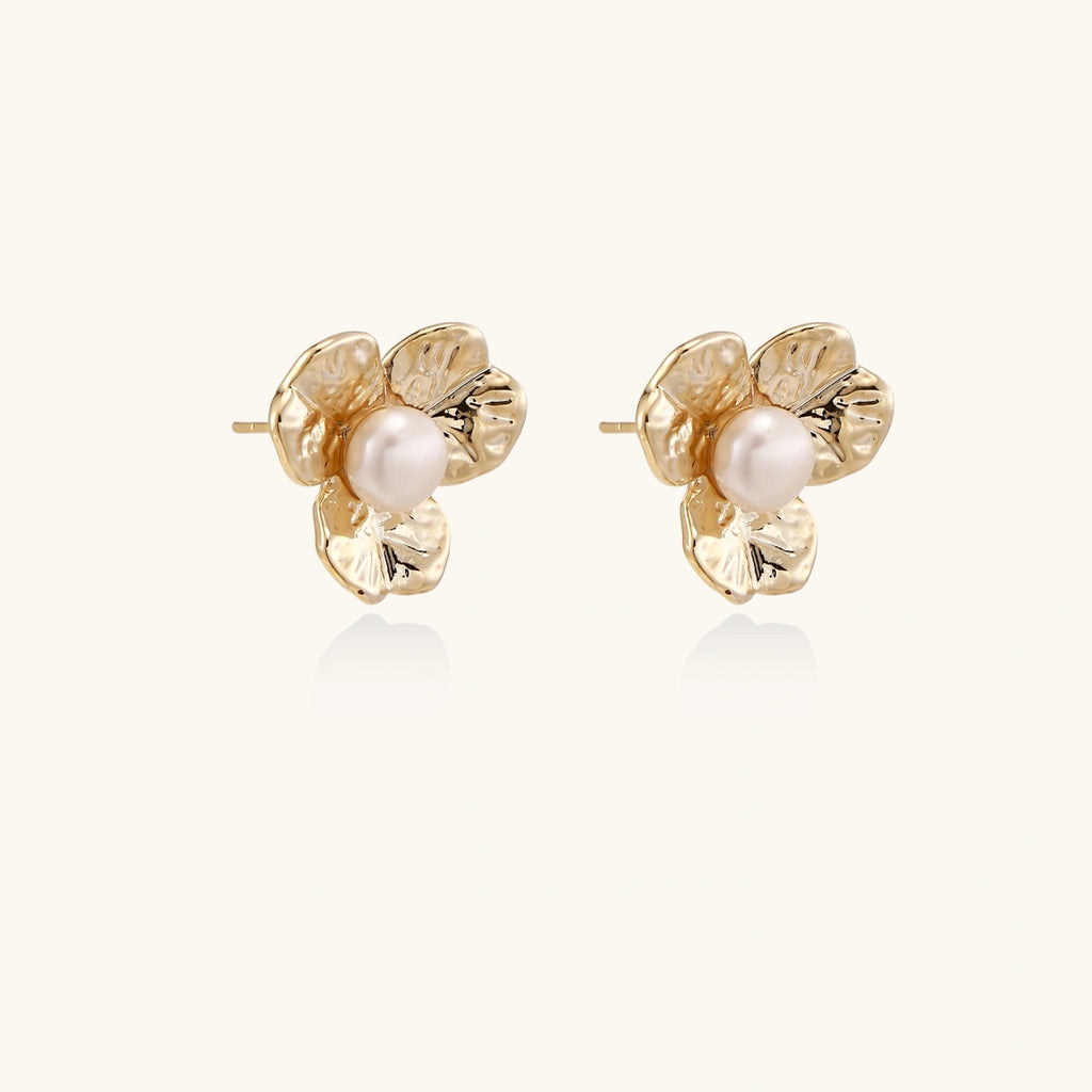 Top view of gold floral bloom pearl stud earrings — 14K eco-brass