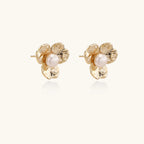 Top view of gold floral bloom pearl stud earrings — 14K eco-brass
