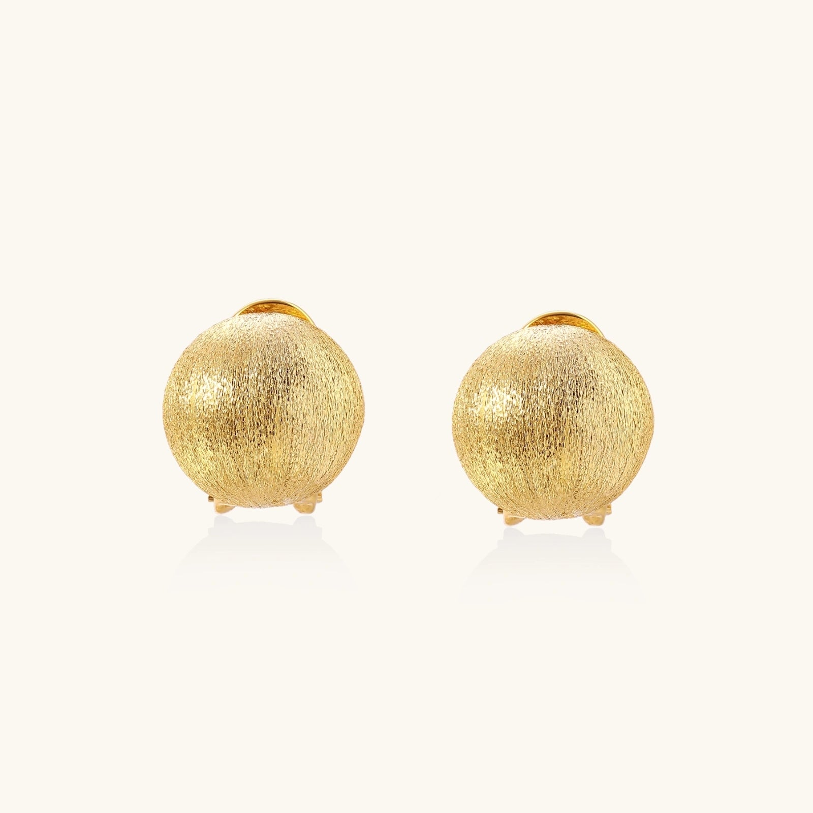 Brushed gold dome clip earrings in 24K gold vermeil on white background