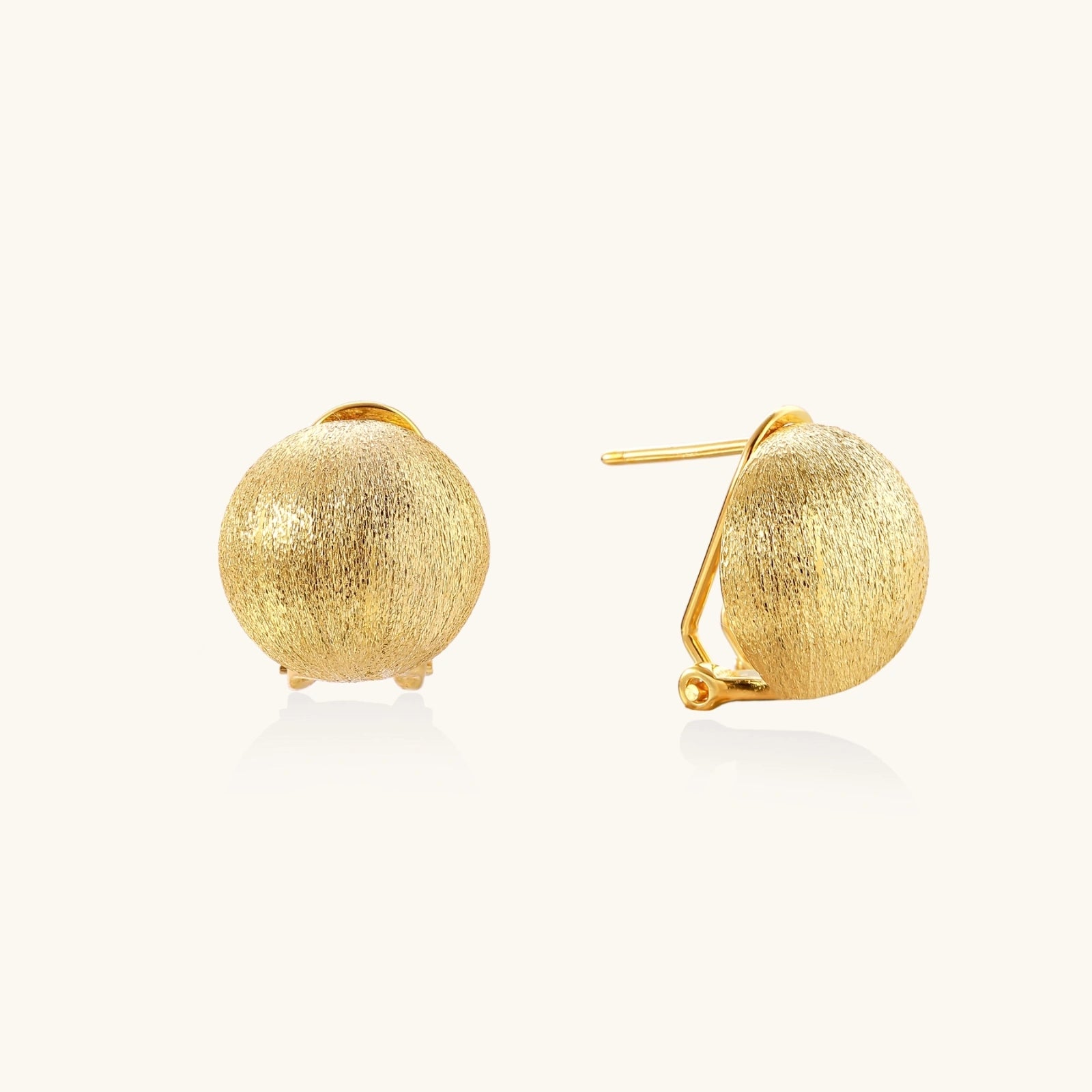 Top view of brushed satin gold dome clip earrings in vermeil