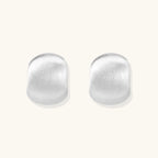 Brushed silver stud earrings in pure sterling silver dome on white background