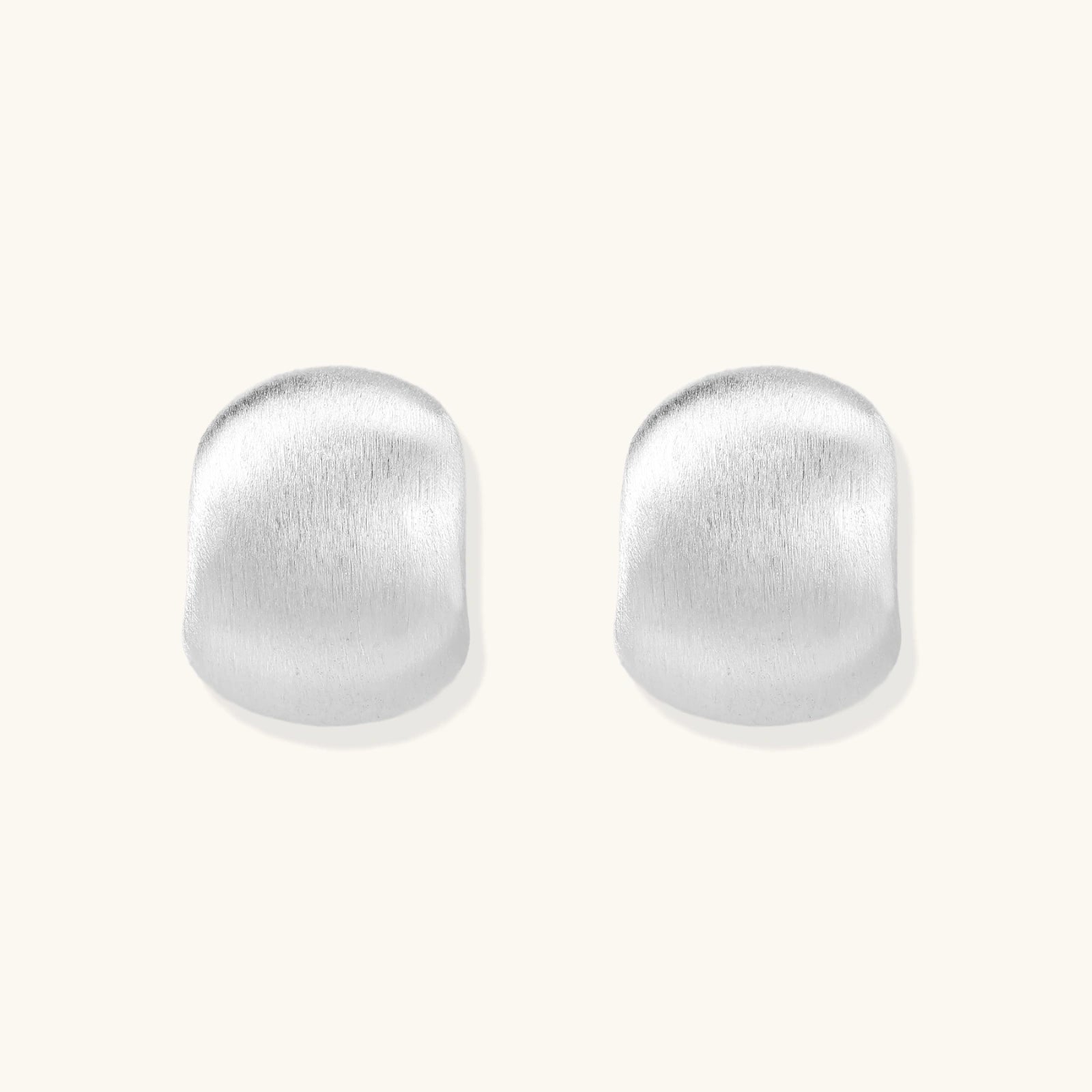 Brushed silver stud earrings in pure sterling silver dome on white background