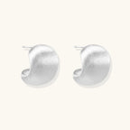 Side view of matte brushed sterling silver dome stud earrings