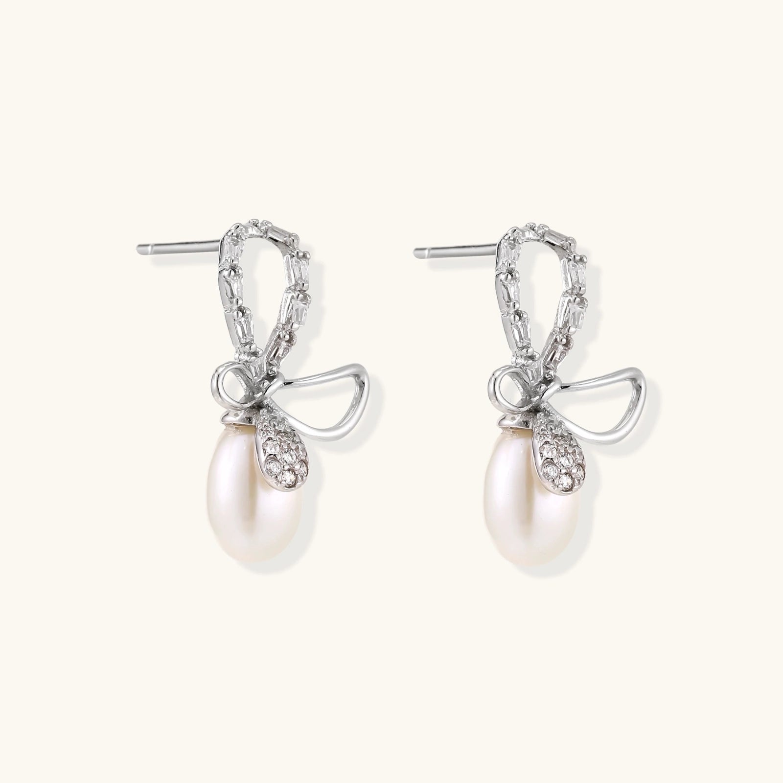 Dainty freshwater pearl earrings with baguette crystal bow detail