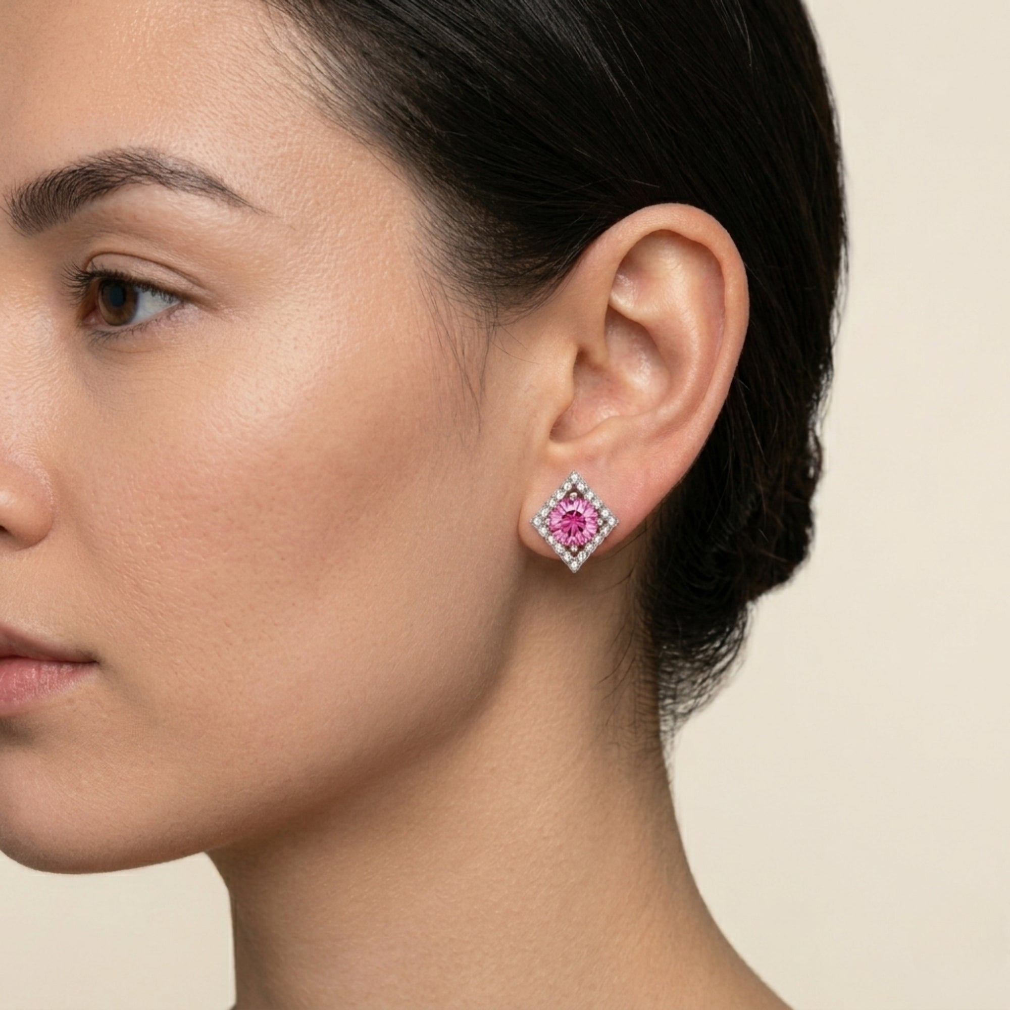Woman wearing diamond halo stud earrings — brilliant pink moissanite jewelry