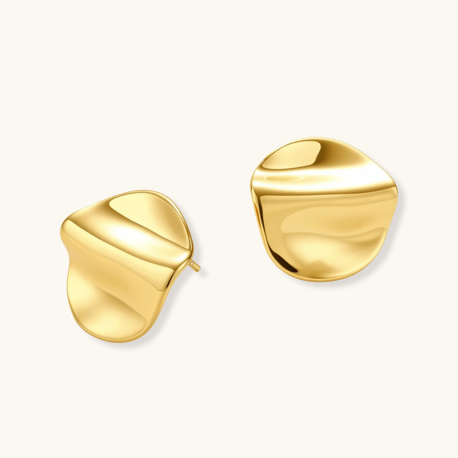 Close-up of organic sculptural folds on gold flow statement stud earrings