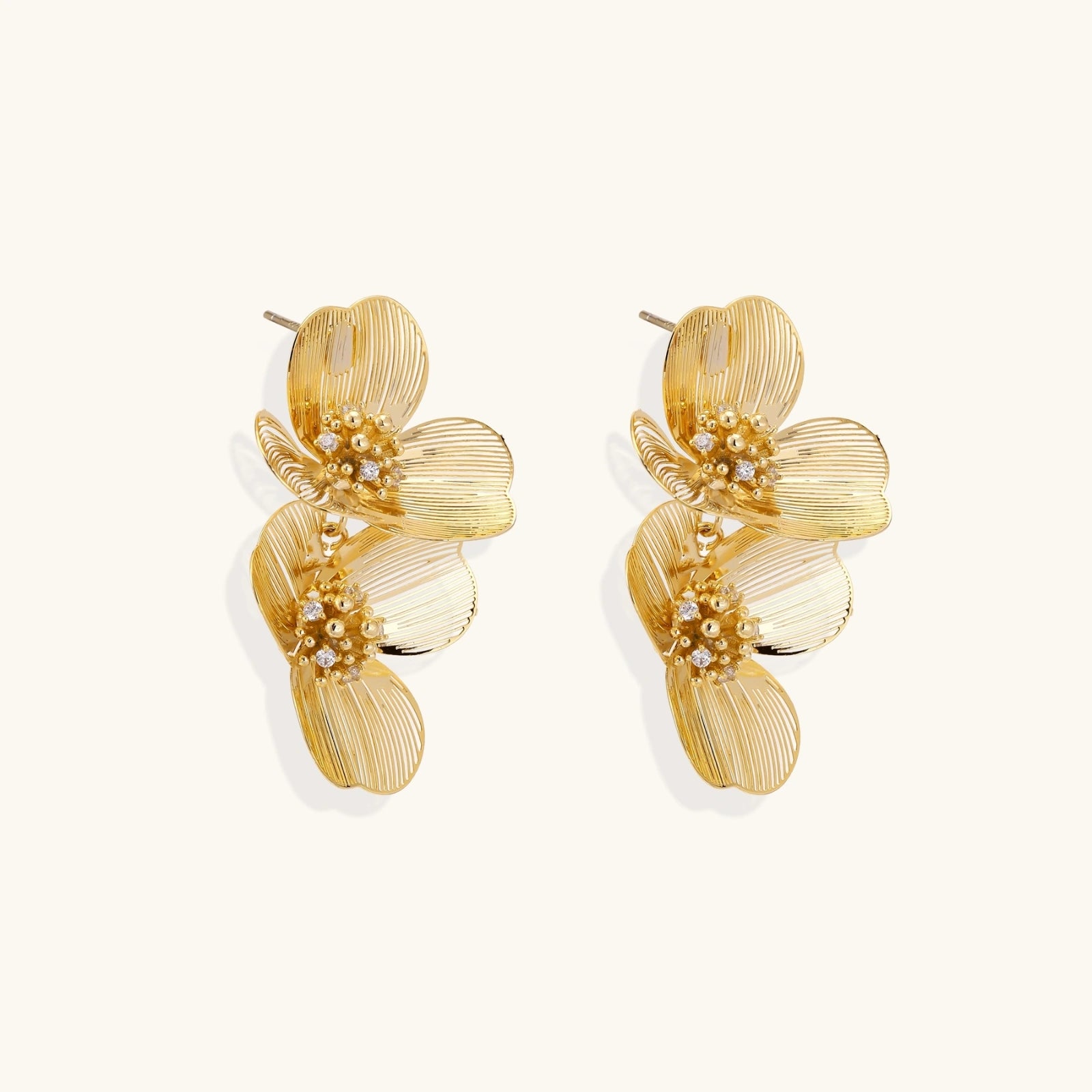 Close-up of crystal-kissed centers on golden bloom double floral earrings