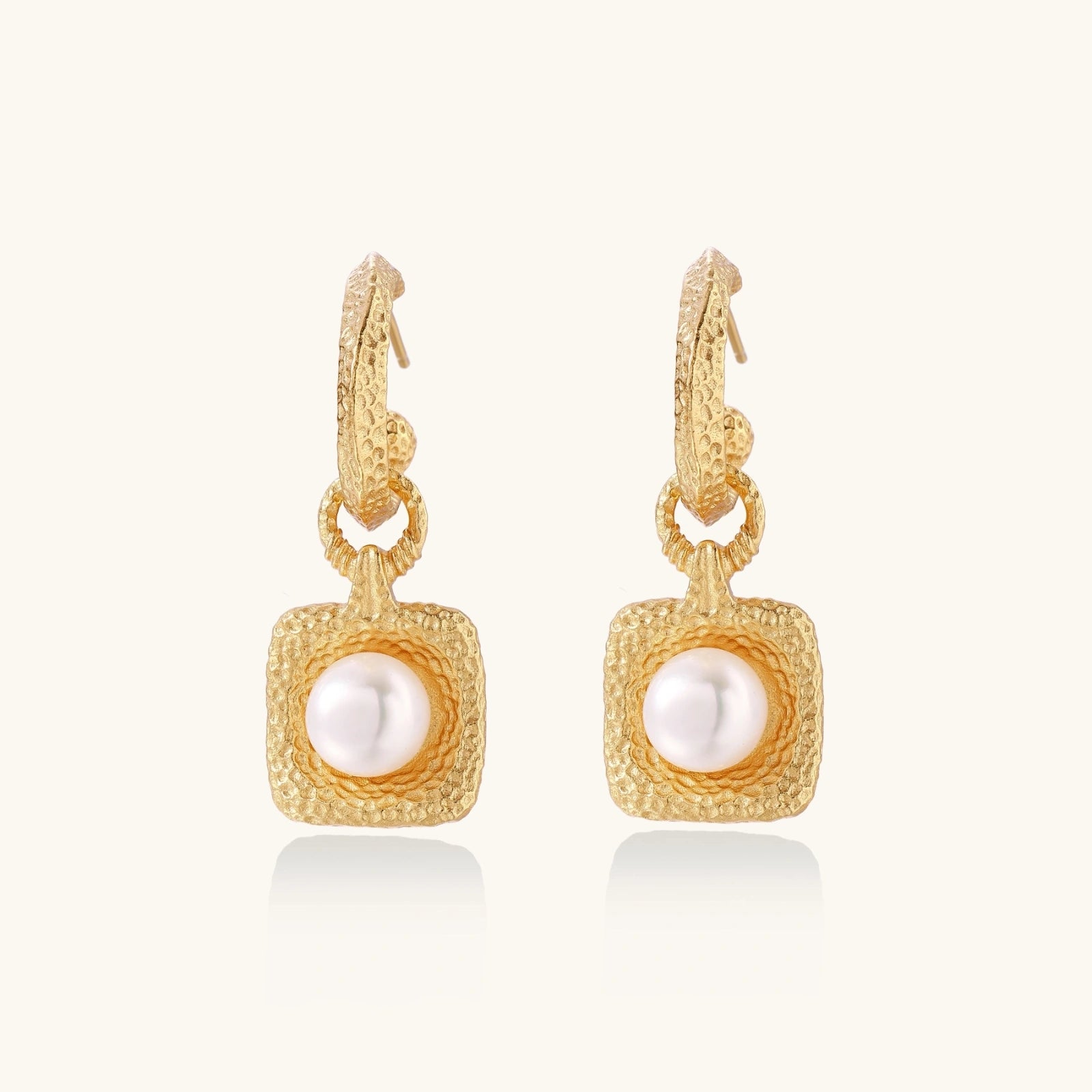 Golden pearl drop hoop earrings in 24K vermeil with freshwater pearl on white background
