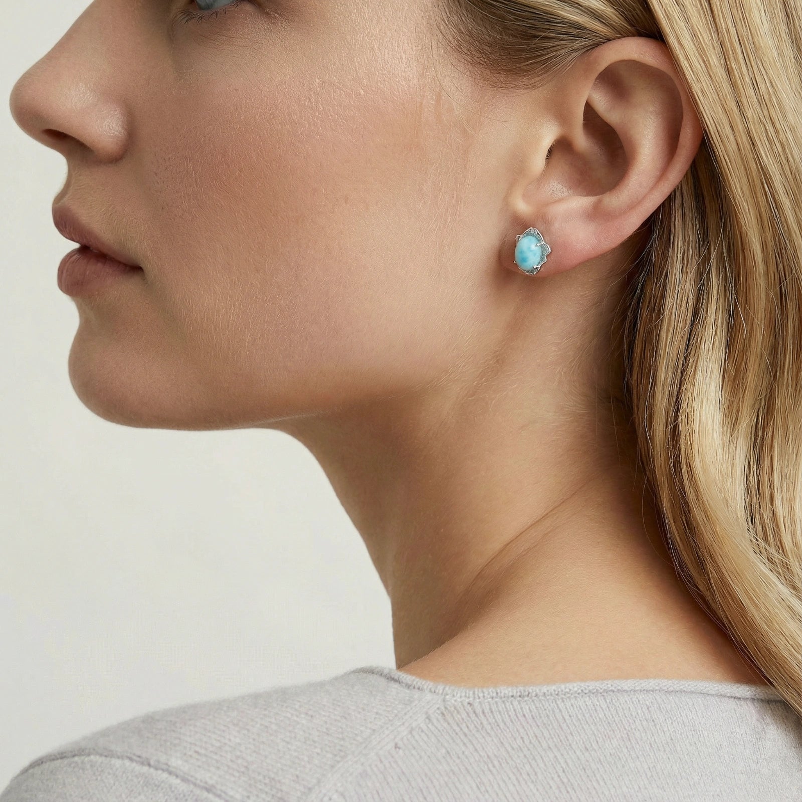 Woman wearing larimar dream stud earrings — rare ocean blue jewelry
