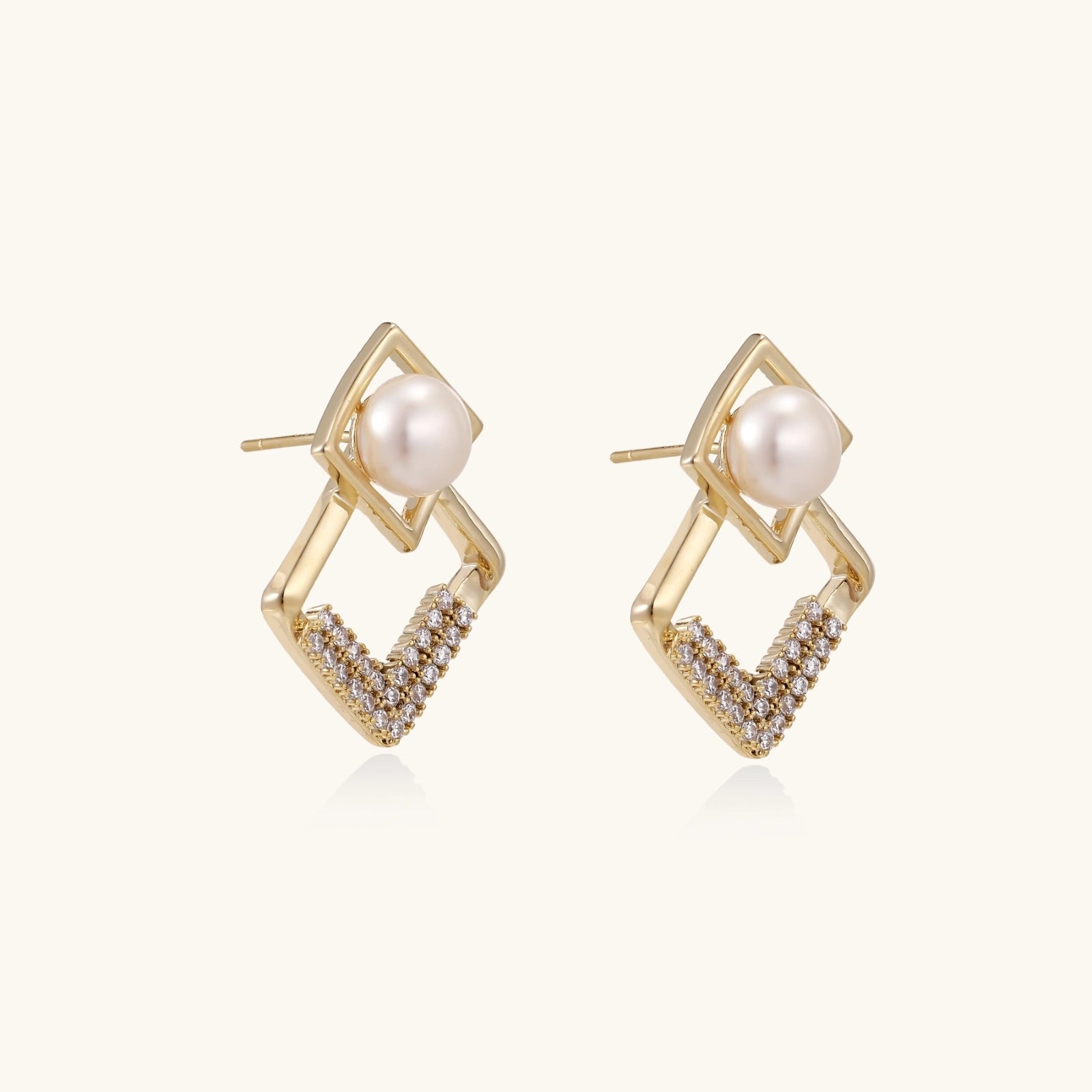 Close-up of freshwater pearl in double geometric gold frame earrings