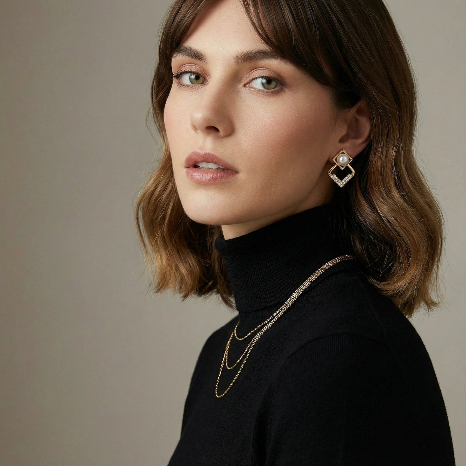 Woman wearing pearl geometry earrings — modern architectural jewelry