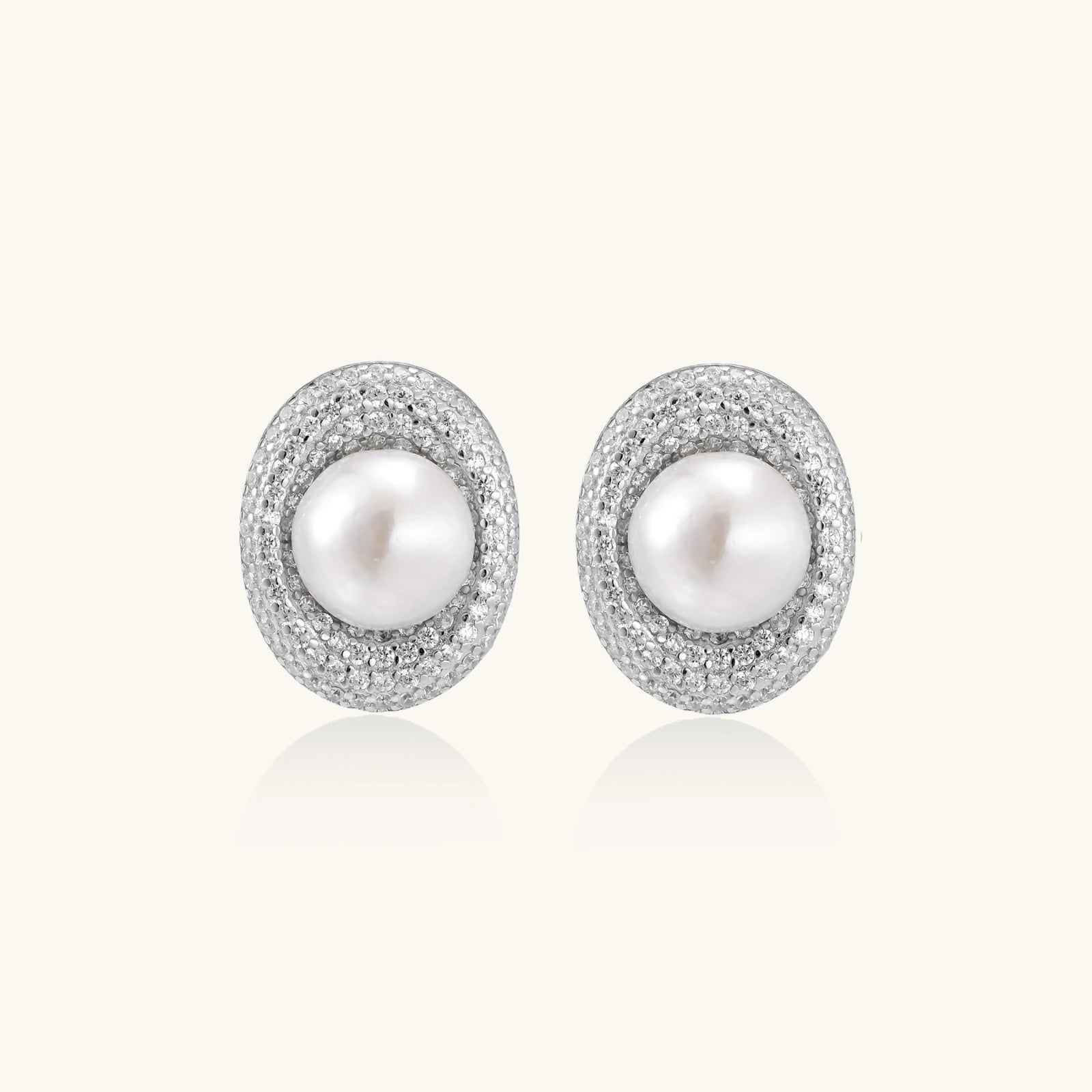 Close-up of freshwater pearl stud earrings with double crystal halo detail