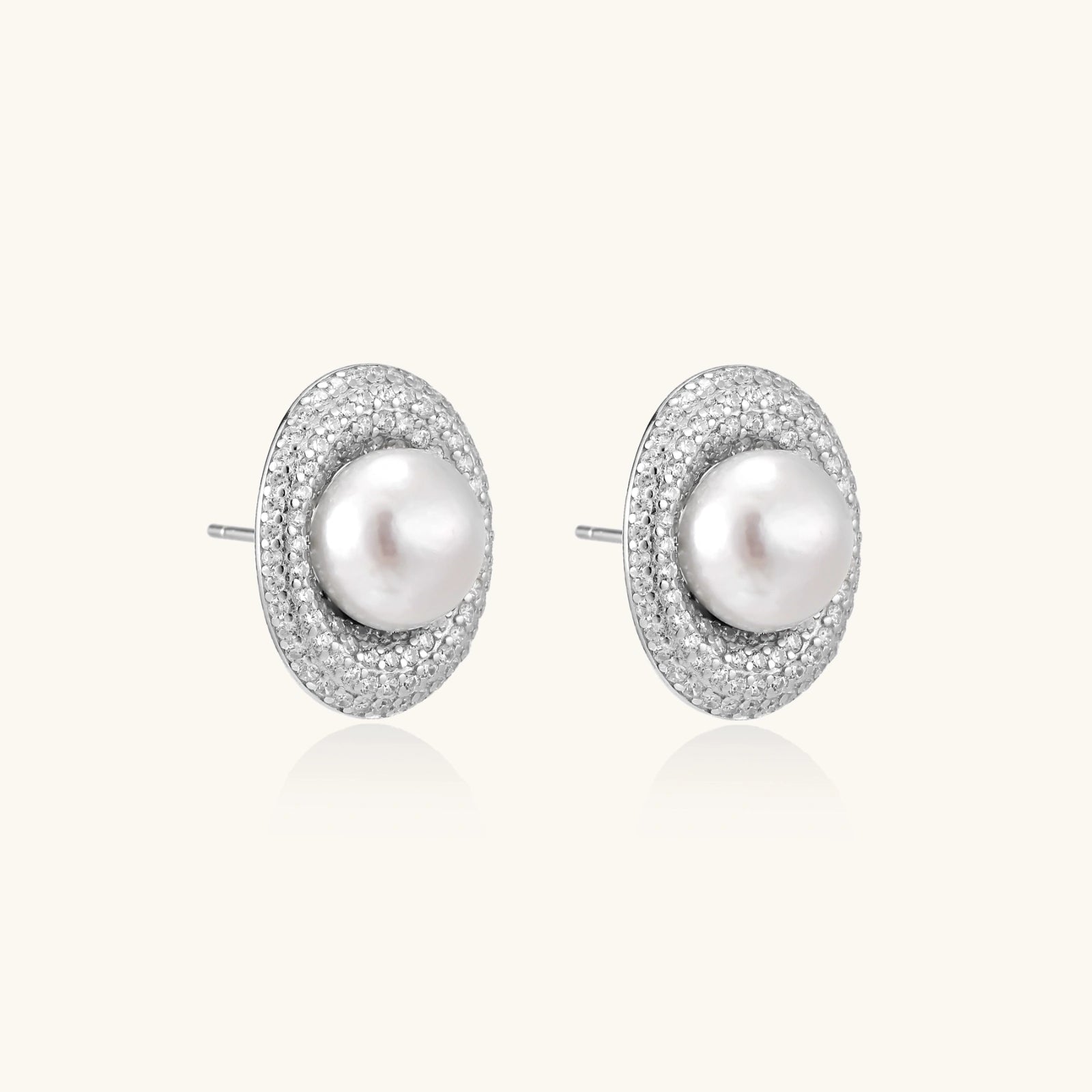 Side view of rhodium 925 silver pearl halo stud earrings with pavé crystals