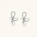 Crystal bow pearl drop earrings with freshwater pearl and pave crystal in rhodium-plated 925 sterling silver, front view | VAHN Jewels