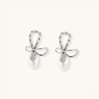 Crystal bow pearl drop earrings with freshwater pearl and pave crystal in rhodium-plated 925 sterling silver, front view | VAHN Jewels