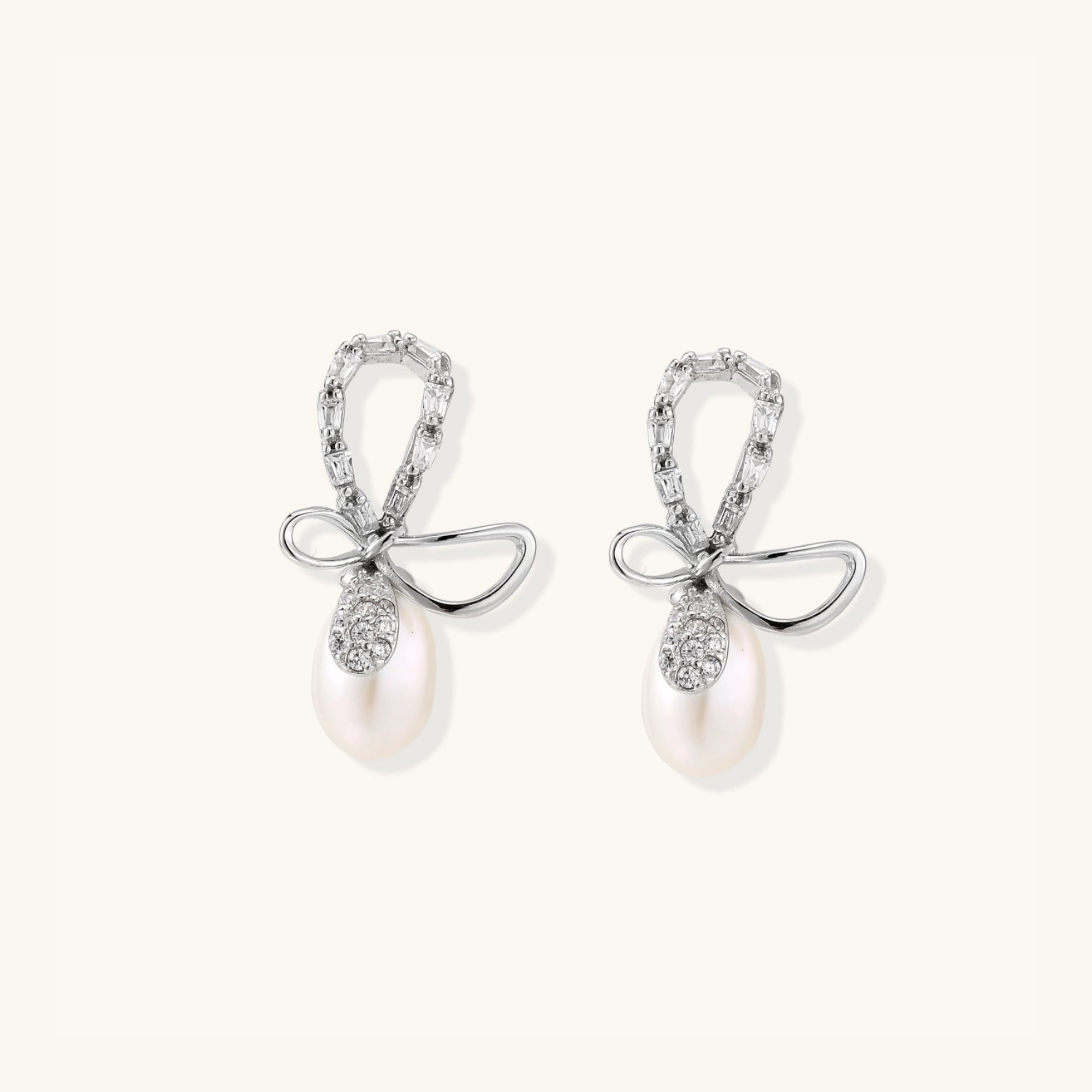 Crystal bow pearl drop earrings with freshwater pearl and pave crystal in rhodium-plated 925 sterling silver, front view | VAHN Jewels