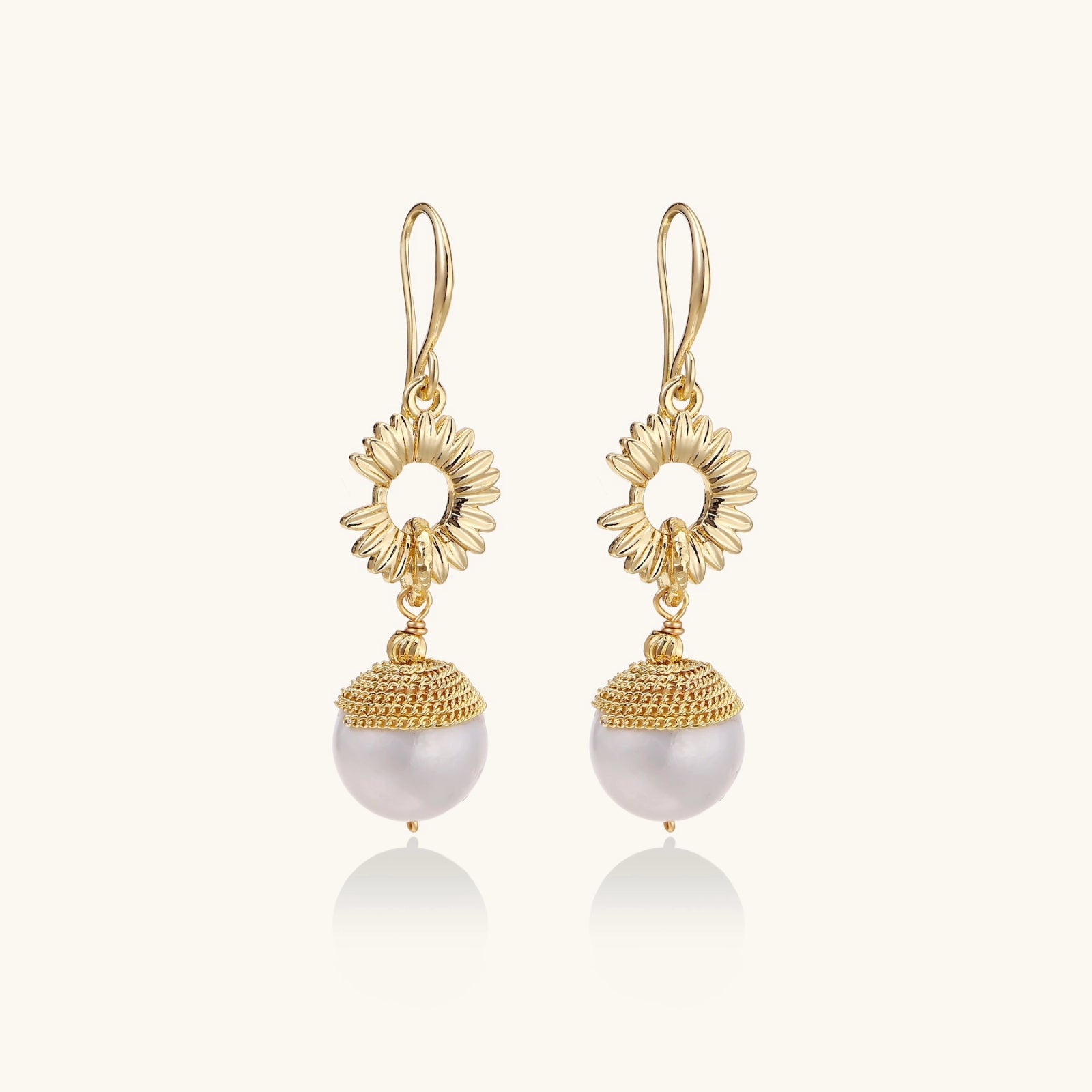 Sunburst pearl dangle earrings front view — 14K gold plated eco-brass