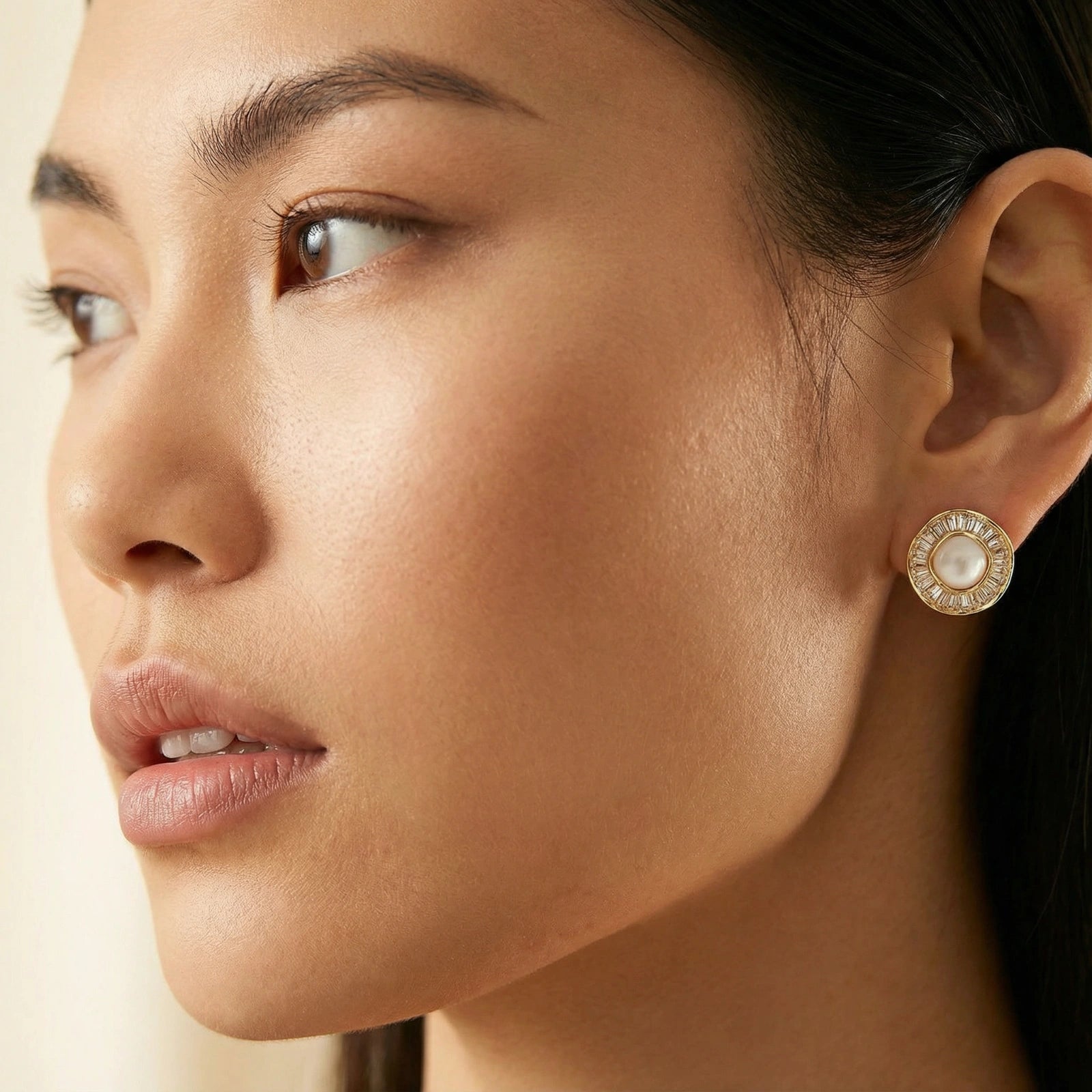Woman wearing sunburst pearl stud earrings — radiant elegant jewelry