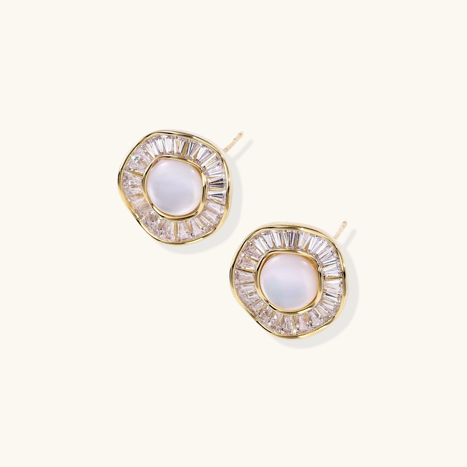  Close-up of baguette crystal halo on yellow gold sunburst pearl stud earrings