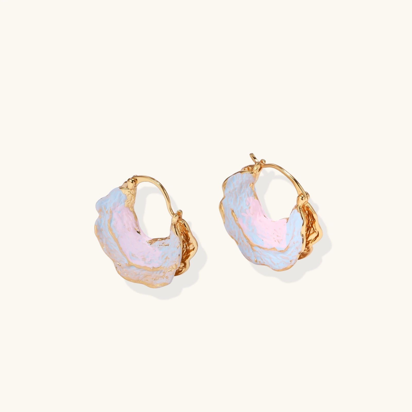 Close-up of iridescent blush and sky enamel on tide pool hoop earrings