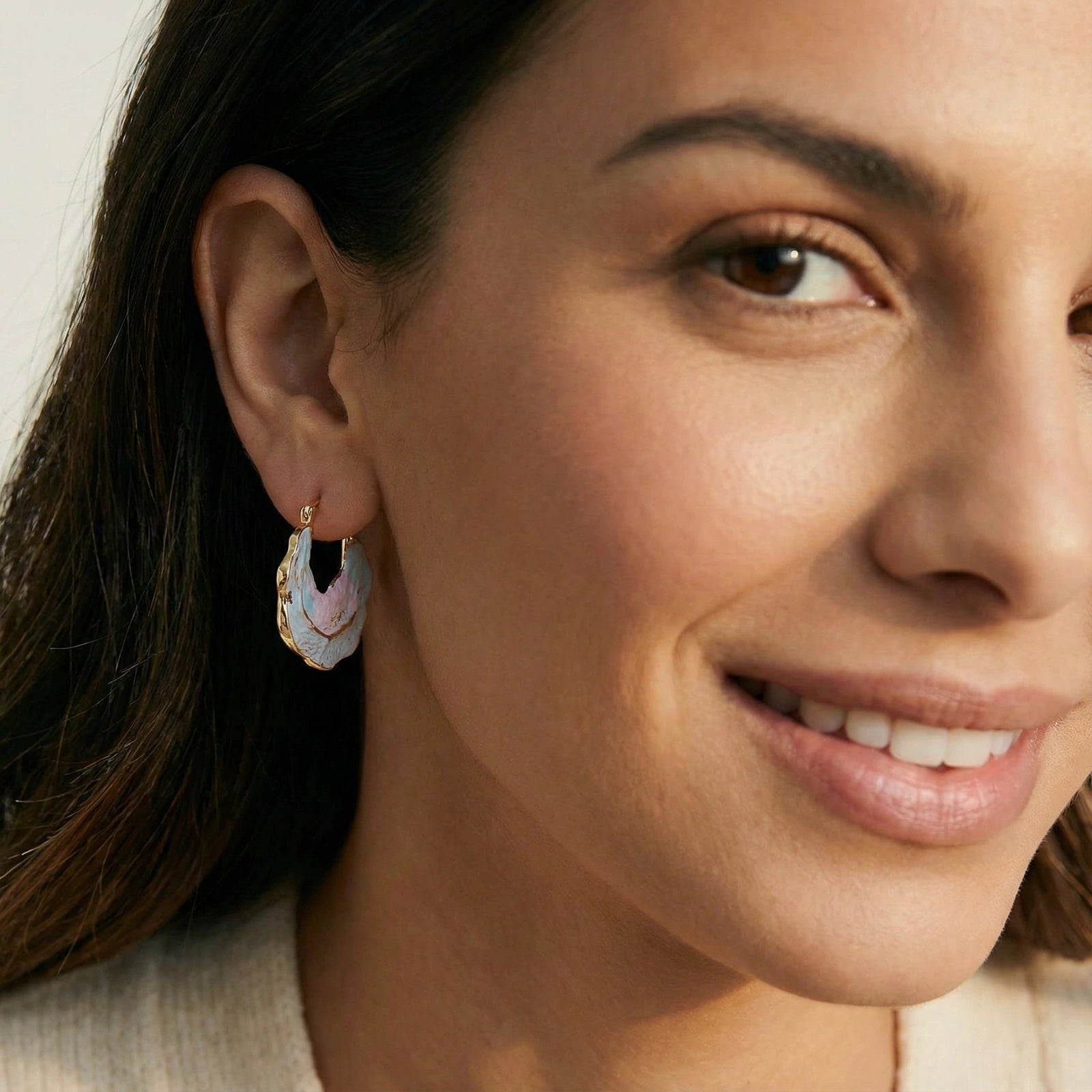 Woman wearing tide pool hoop earrings — coastal aesthetic jewelry