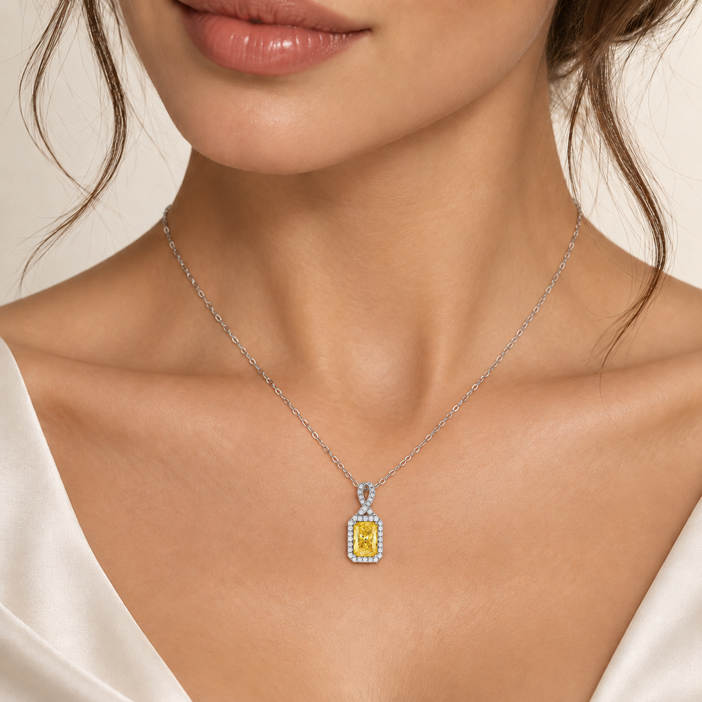 Yellow moissanite halo pendant necklace in platinum-plated 925 sterling silver worn by a woman